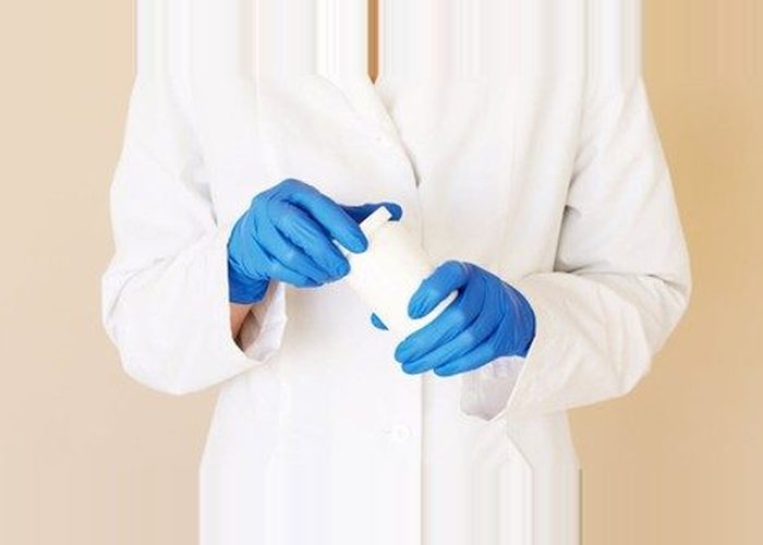 doctor holding a vial.