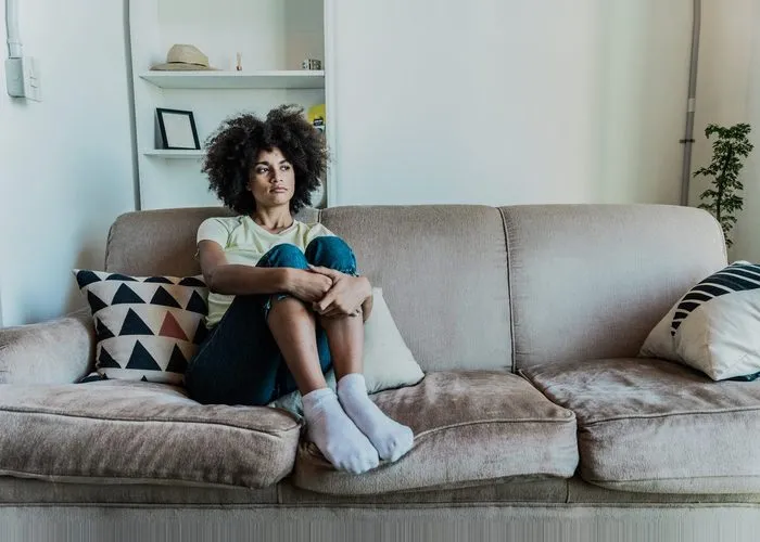 Woman looking lonely on her bed.