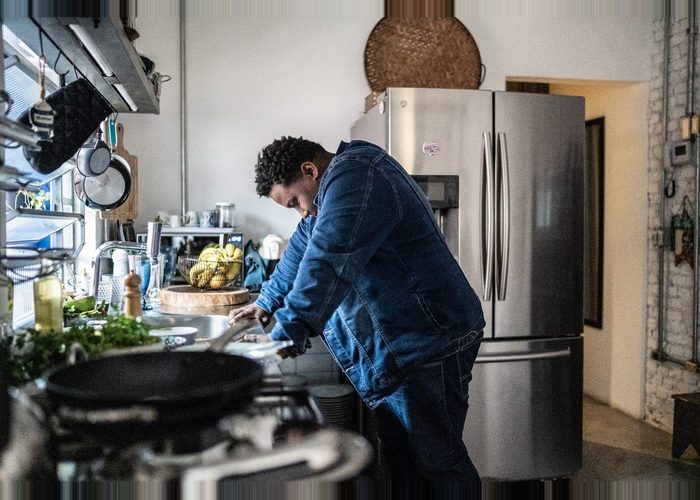 man suffering from burnout in his kitchen.