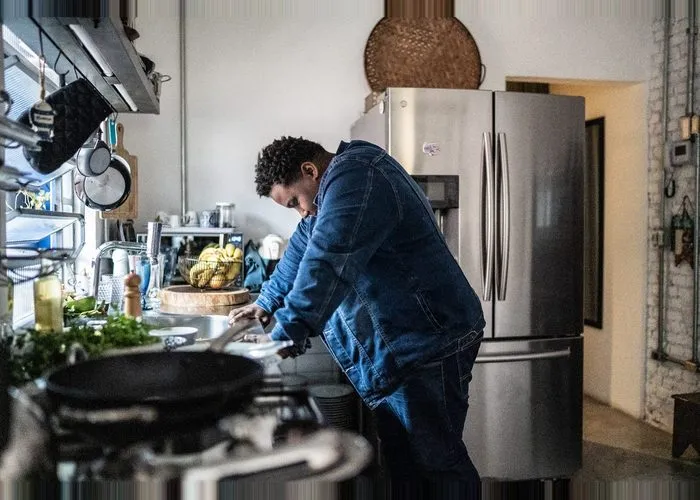 man suffering from burnout in his kitchen.